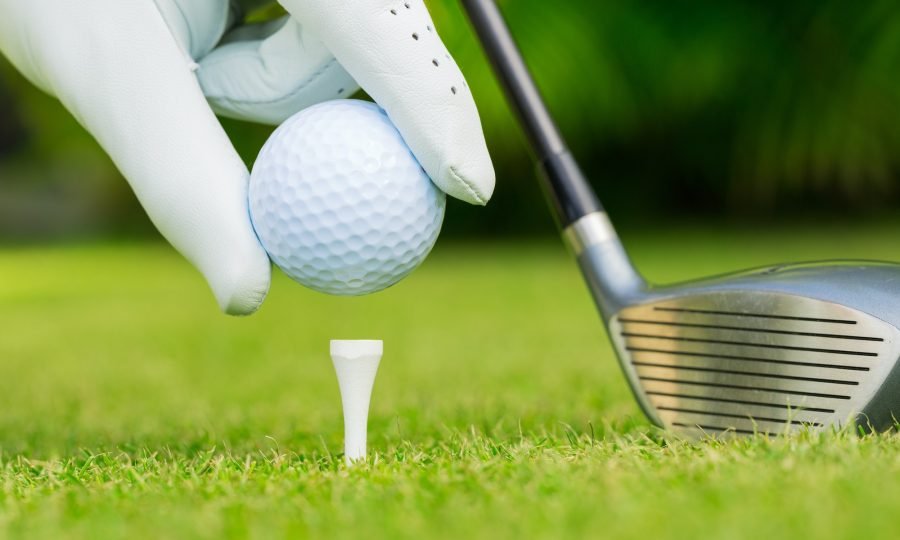 Close up view of golf ball on tee on golf course